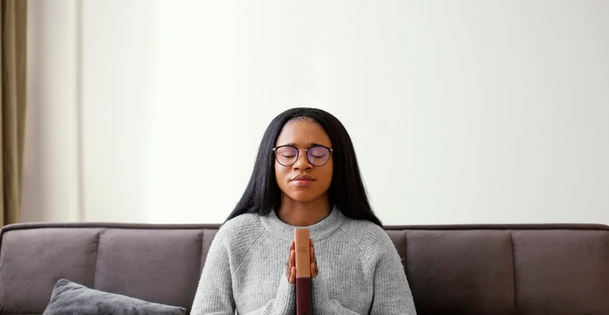 A calm student practicing mindfulness or deep breathing, representing stress management techniques during exam preparation.