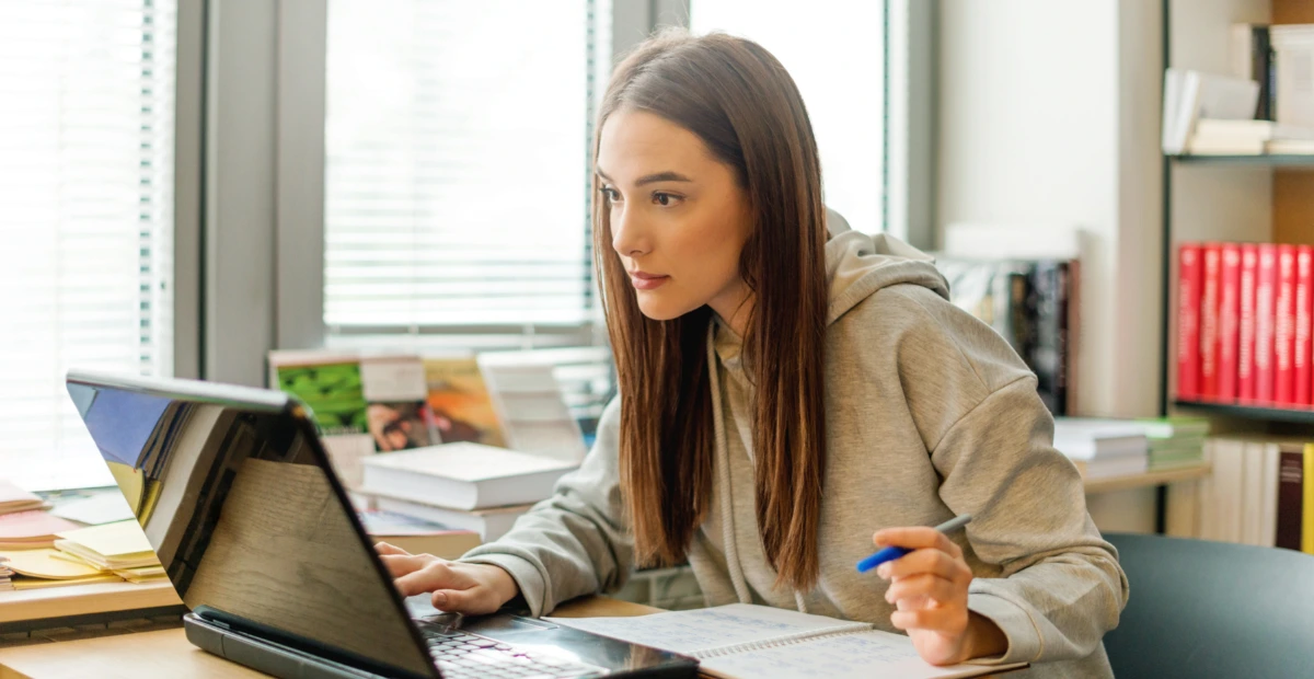 a woman looking a laptop